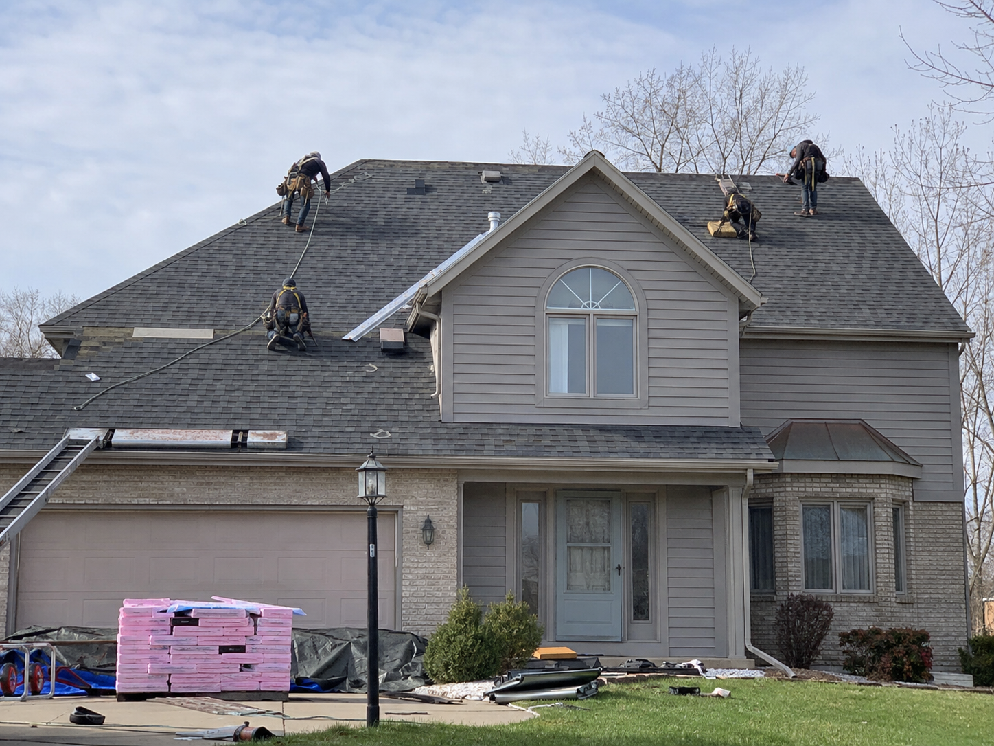 Roofing crew working on a residential home